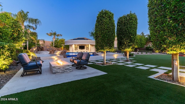 view of yard with a patio and an outdoor fire pit