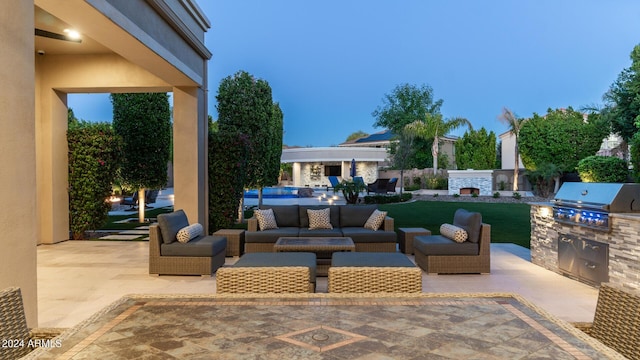 view of patio / terrace with an outdoor living space, a grill, and exterior kitchen