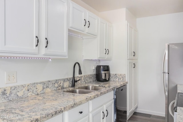 5921 W Golden Ln, Glendale, AZ 85302 - kitchen featuring electric stove, a sink, white cabinetry, freestanding refrigerator, and dishwashing machine