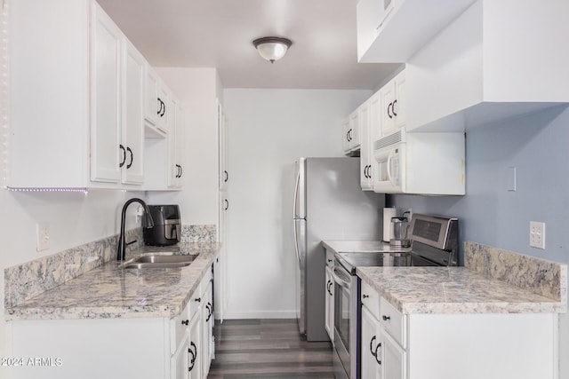 5921 W Golden Ln, Glendale, AZ 85302 - kitchen featuring appliances with stainless steel finishes, white cabinetry, light countertops, and a sink