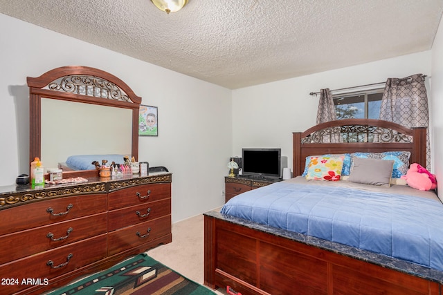 carpeted bedroom featuring a textured ceiling