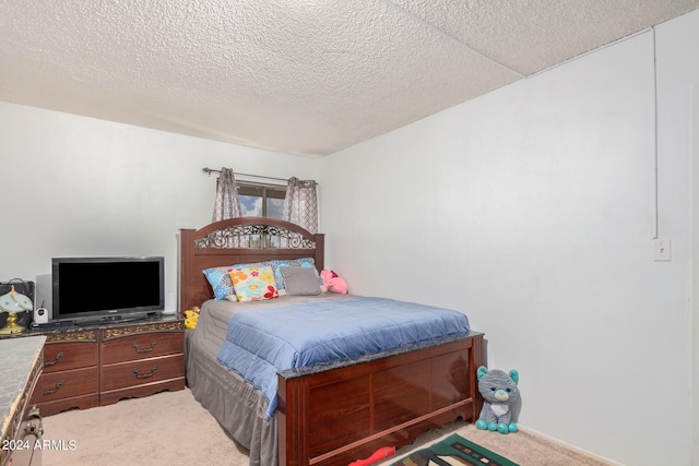 bedroom featuring a textured ceiling and carpet flooring