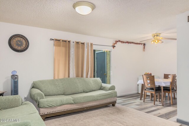 5921 W Golden Ln, Glendale, AZ 85302 - living room with baseboards, a textured ceiling, wood finished floors, and a ceiling fan
