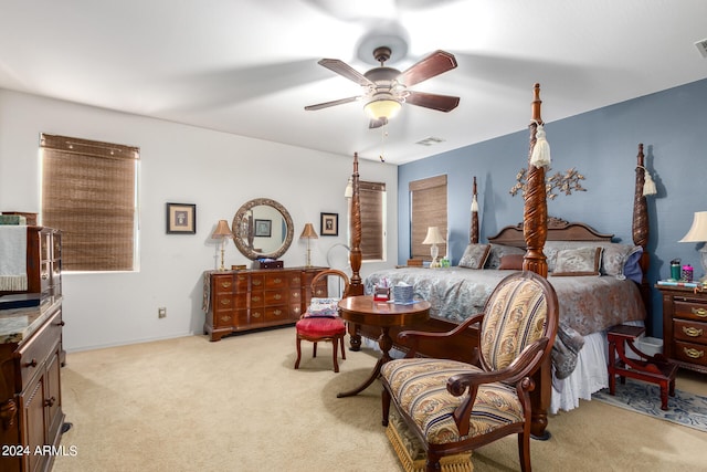 bedroom with ceiling fan and light carpet