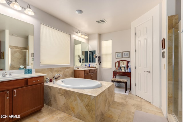 bathroom featuring vanity, independent shower and bath, and tile patterned floors