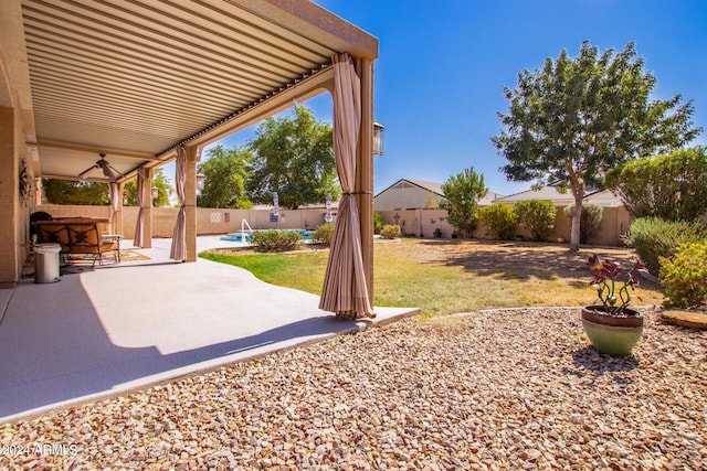 view of yard with a patio area and ceiling fan