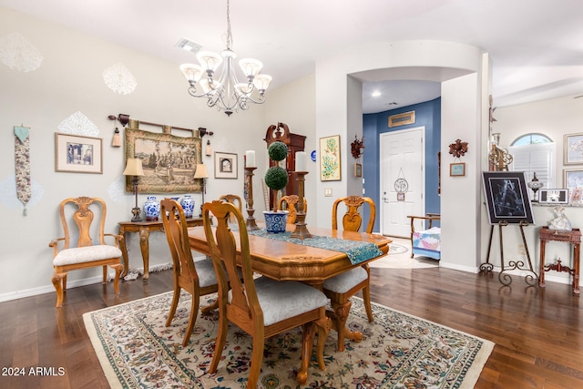 dining space featuring a chandelier and dark wood-type flooring