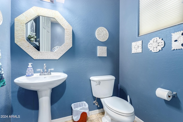 bathroom featuring sink, toilet, and tile patterned flooring