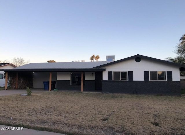 ranch-style home with a carport, cooling unit, and brick siding