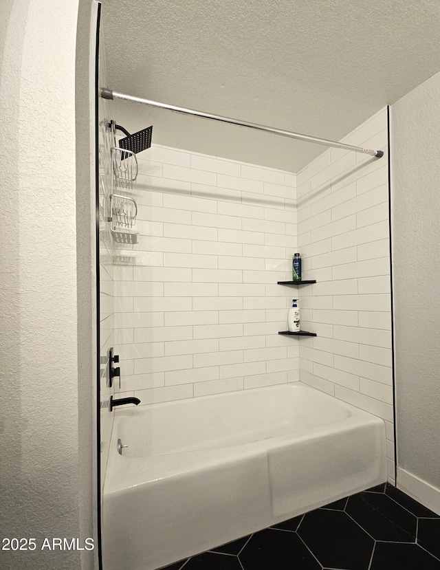 bathroom featuring tiled shower / bath combo, tile patterned flooring, and a textured ceiling