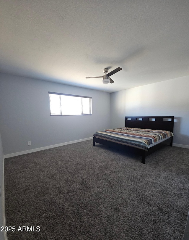 bedroom with ceiling fan and dark carpet