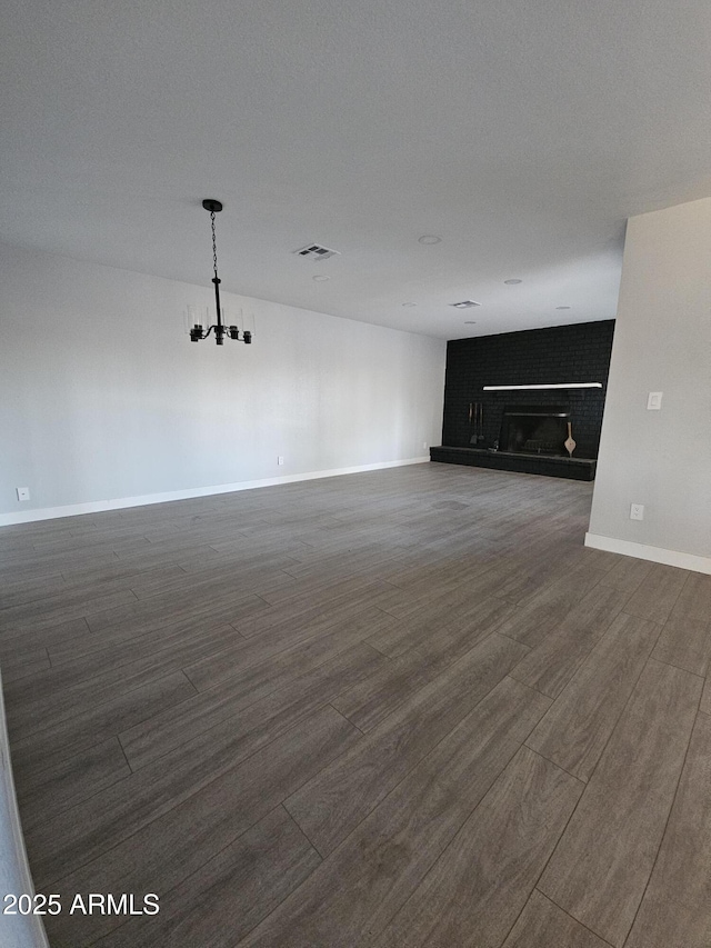 unfurnished living room featuring a brick fireplace