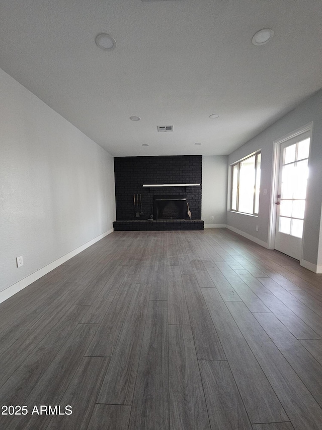 unfurnished living room with a fireplace and hardwood / wood-style floors