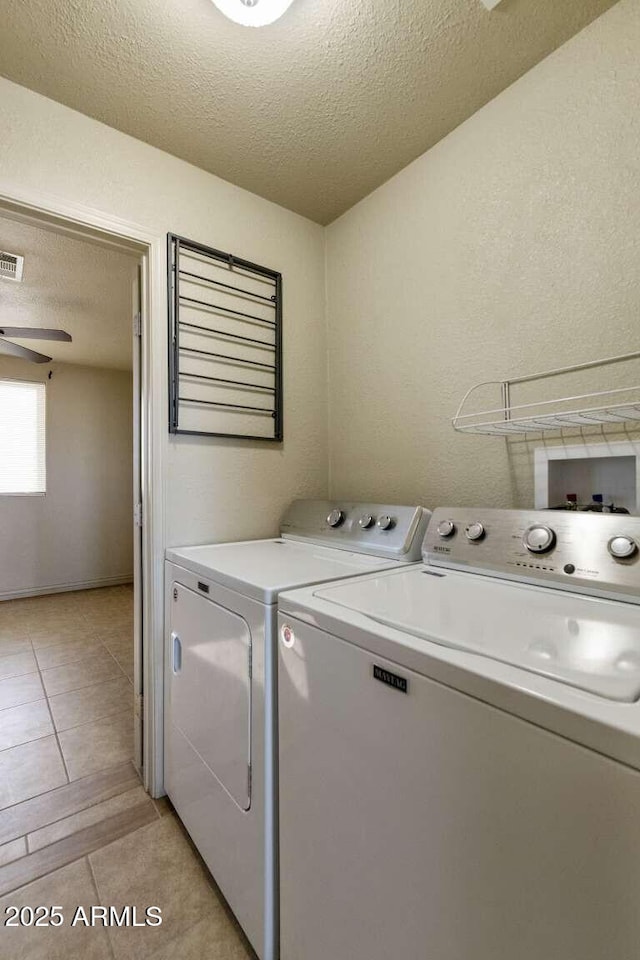 13245 N Betty Angel Way, Florence, AZ 85132 - clothes washing area with washing machine and clothes dryer, a textured ceiling, light tile patterned floors, and a ceiling fan