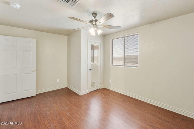 13245 N Betty Angel Way, Florence, AZ 85132 - unfurnished room with wood finished floors, baseboards, ceiling fan, and a smoke detector