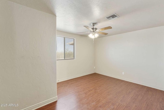 13245 N Betty Angel Way, Florence, AZ 85132 - empty room featuring ceiling fan, wood finished floors, baseboards, and a textured ceiling