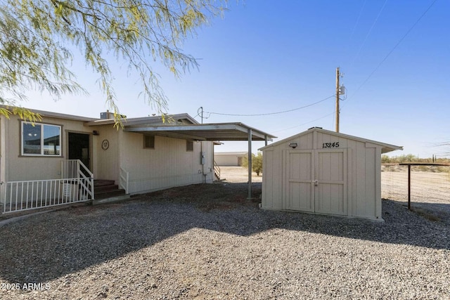 13245 N Betty Angel Way, Florence, AZ 85132 - view of side of home featuring a storage unit, fence, and an outdoor structure