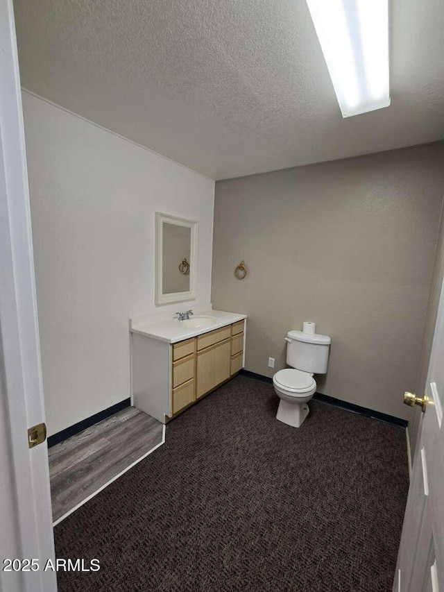 13245 N Betty Angel Way, Florence, AZ 85132 - bathroom with toilet, vanity, a textured ceiling, and baseboards