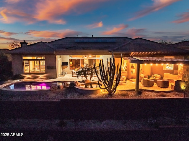 rear view of house with an outdoor living space, a patio area, and an outdoor pool