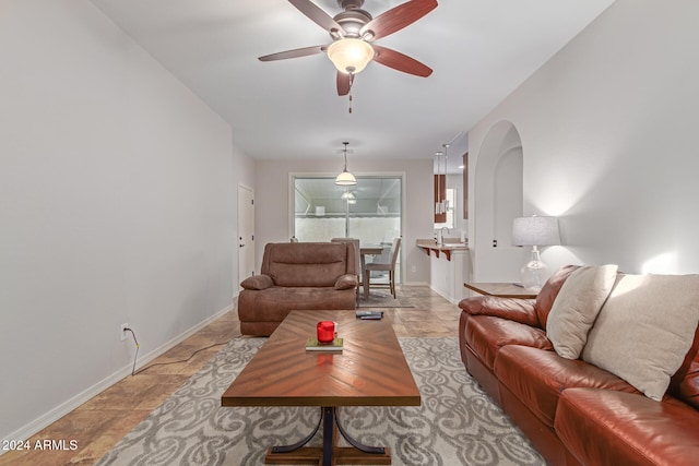 living room with ceiling fan and sink