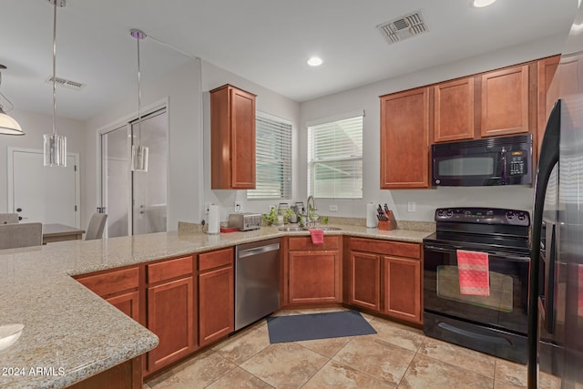 kitchen with black appliances, sink, decorative light fixtures, and light stone counters