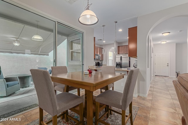 dining space with light tile patterned flooring and ceiling fan