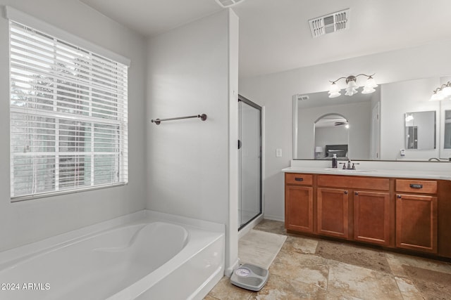 bathroom featuring vanity and plus walk in shower