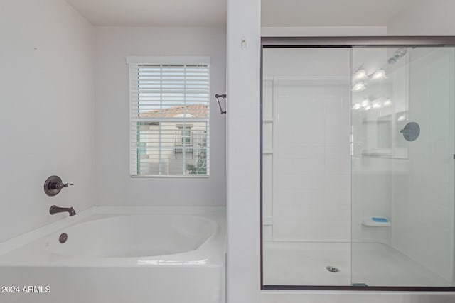 bathroom featuring separate shower and tub