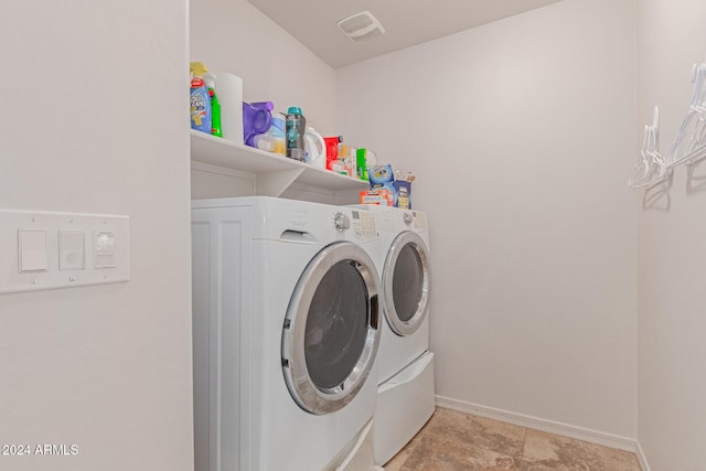 clothes washing area featuring washing machine and clothes dryer