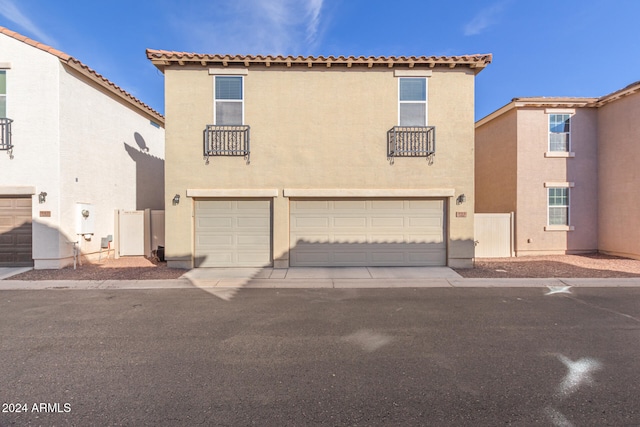 mediterranean / spanish-style house with a garage