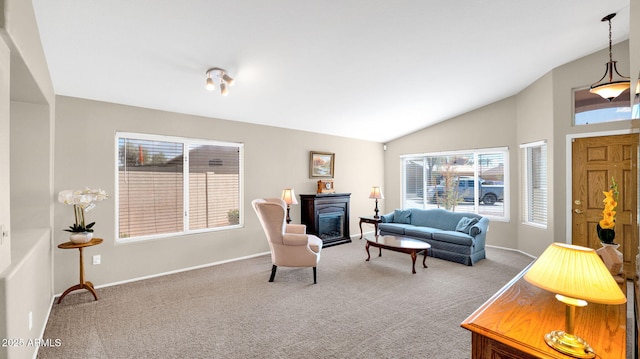 carpeted living area with a glass covered fireplace, lofted ceiling, and baseboards