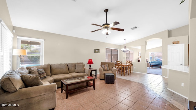 living area featuring light tile patterned floors, visible vents, arched walkways, vaulted ceiling, and ceiling fan with notable chandelier