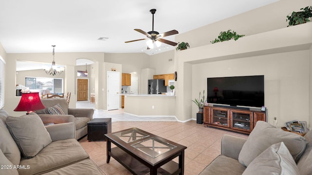 living room with lofted ceiling, light tile patterned flooring, ceiling fan with notable chandelier, and visible vents