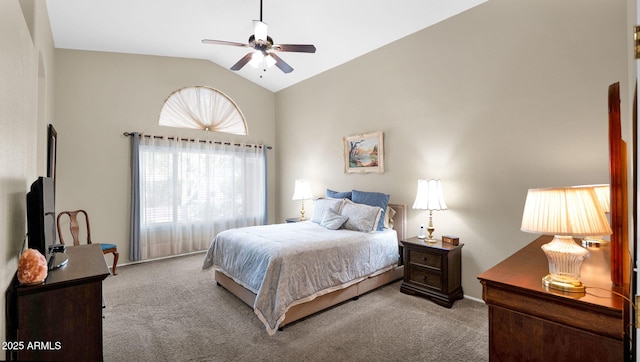 carpeted bedroom with vaulted ceiling and a ceiling fan