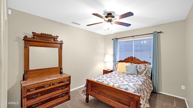 bedroom with a ceiling fan, visible vents, dark colored carpet, and baseboards