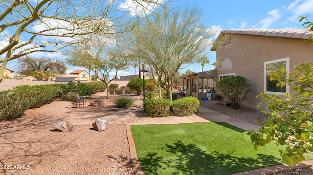 view of yard featuring a patio area and a fire pit