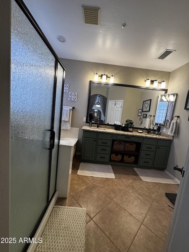 full bath featuring a stall shower, tile patterned flooring, and visible vents