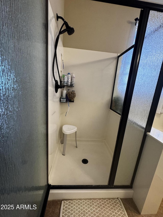 bathroom with a shower stall