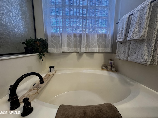 full bath featuring a bath and a healthy amount of sunlight