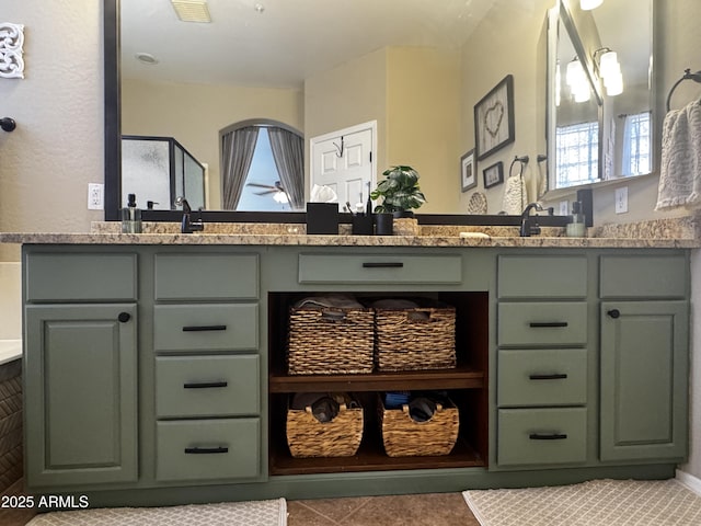 bathroom with a wealth of natural light, visible vents, vanity, and ceiling fan