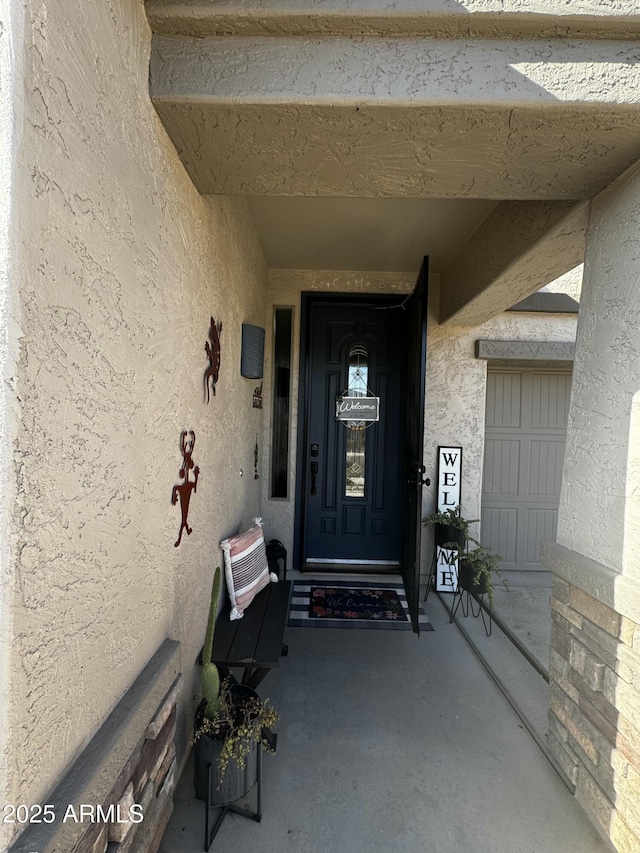 property entrance featuring stucco siding
