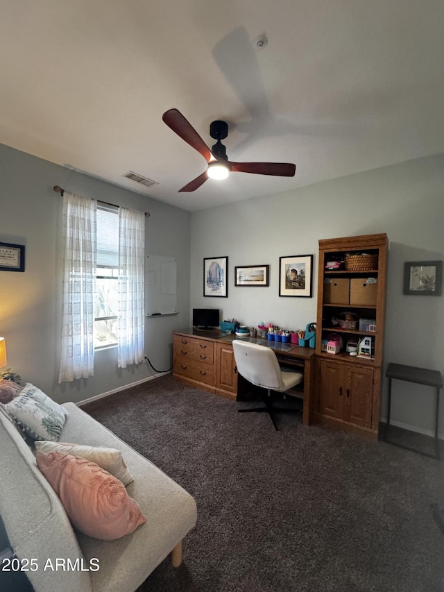 carpeted office featuring baseboards, a ceiling fan, and visible vents
