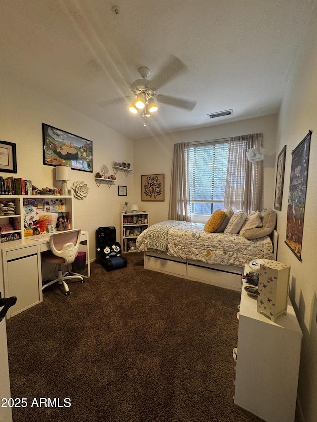 carpeted bedroom with a ceiling fan and visible vents