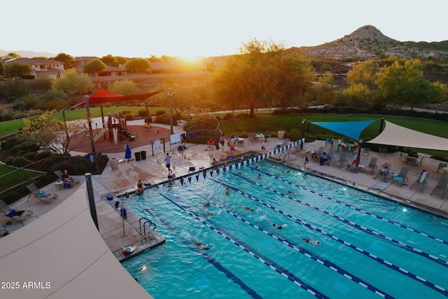 view of pool with a mountain view and a patio area