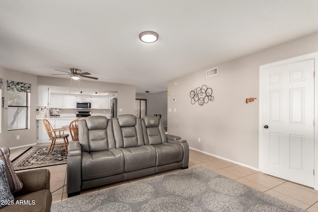 living room with ceiling fan and light tile patterned floors