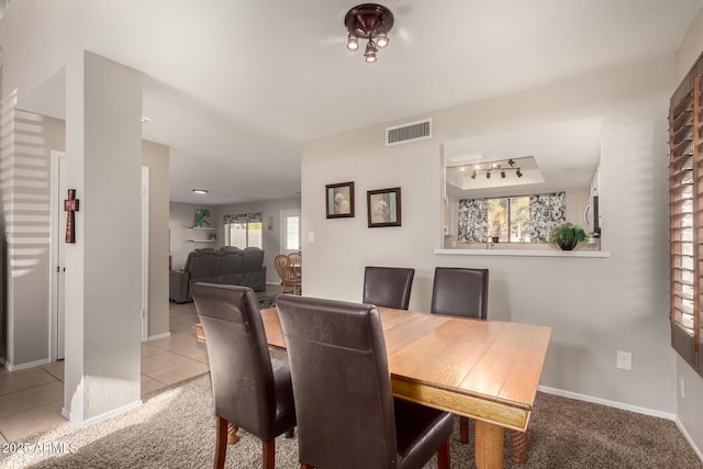 dining area featuring light colored carpet