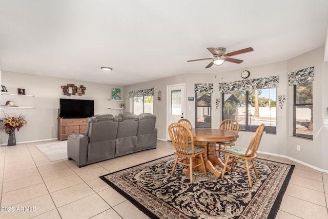 tiled dining space featuring ceiling fan