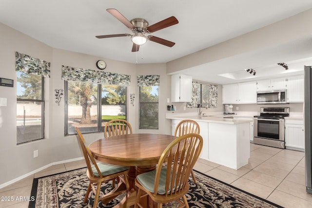 tiled dining room with ceiling fan