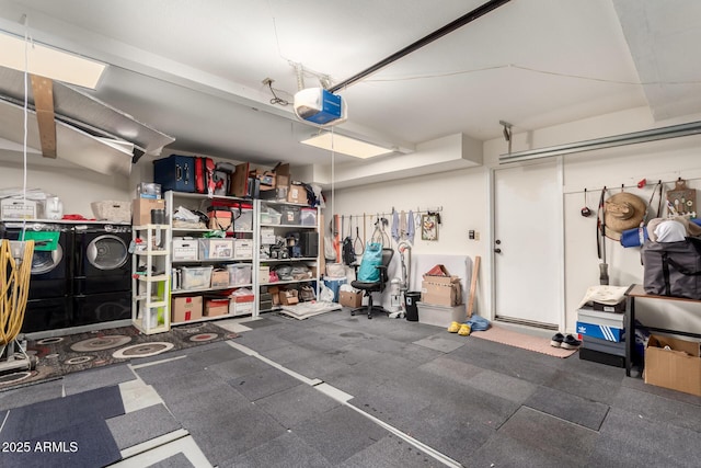 garage with independent washer and dryer and a garage door opener