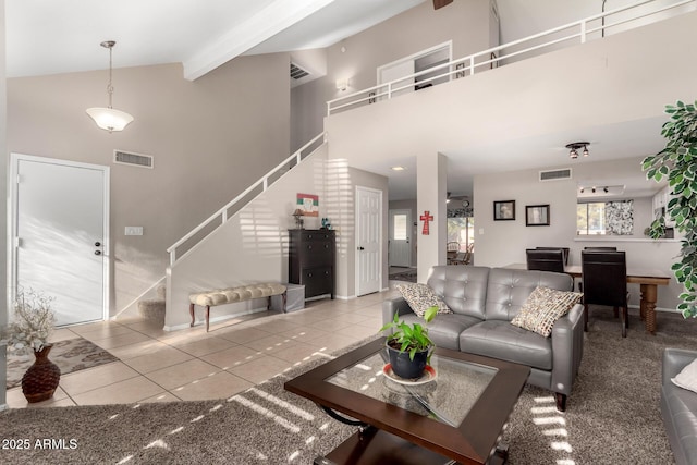 living room featuring beam ceiling, a wealth of natural light, high vaulted ceiling, and tile patterned floors